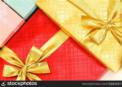 Close up of gift boxes with golden ribbons