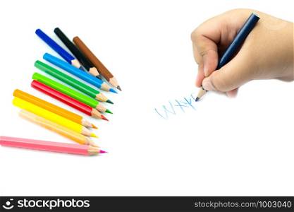 Close up of girl hand with pencil writing english words by hand on white notepad paper at white background, Child learning to write letters of the alphabet, A child is holding a crayon in his hands at paper and crayons for drawing