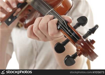 close up of girl playing the Viola against a white background