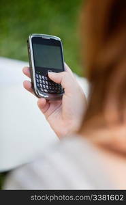 Close-up of girl&rsquo;s hand holding cell phone