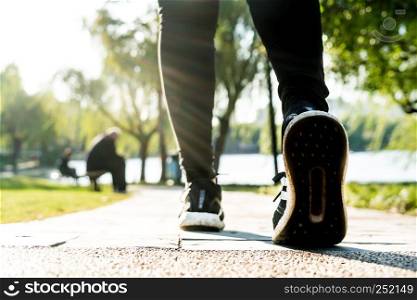 close up of girl shoe while walking in the park, walk for life concept