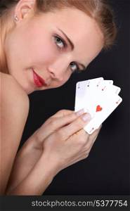 close-up of glamorous blonde with cards