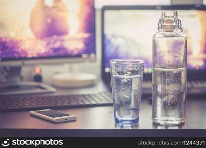 Close up of glass bottle in the office, drinking