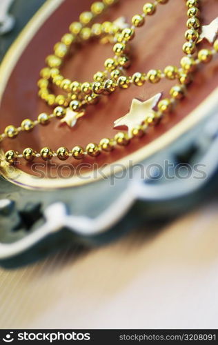 Close-up of golden beads on a tray