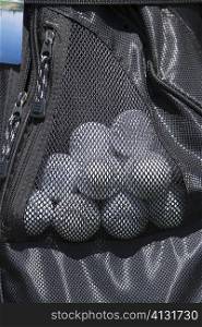 Close-up of golf balls in a golf bag
