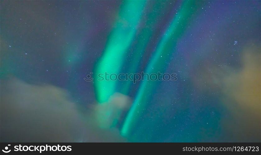 Close up of green aurora northern lights and stars in Lofoten islands, Norway. Sky with polar lights at night in winter season. Nature landscape background.