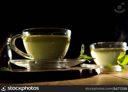 Close-Up Of Green Tea In Cup On Wooden Table