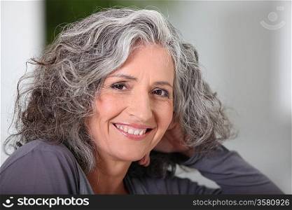 Close-up of grey haired woman at home
