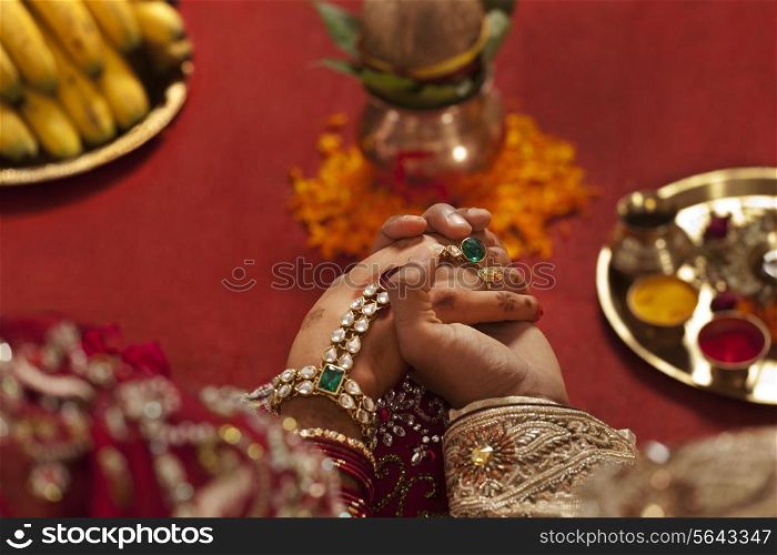Close-up of groom holding brides hand