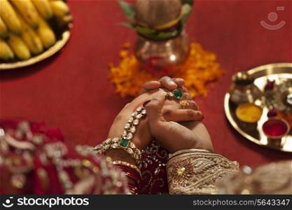 Close-up of groom holding brides hand