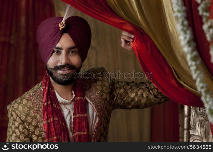 Close-up of groom wearing traditional Sikh wedding costume