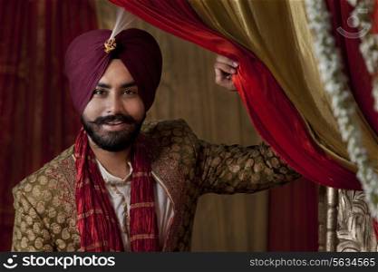 Close-up of groom wearing traditional Sikh wedding costume