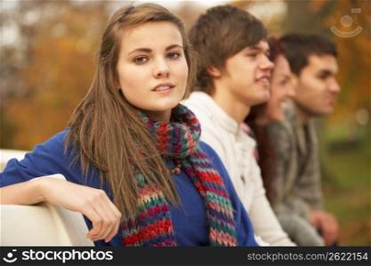 Close Up Of Group Of Teenage Friends In Autumn Park