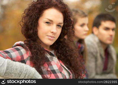 Close Up Of Group Of Teenage Friends In Autumn Park