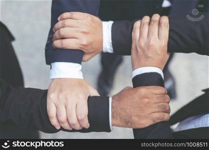 Close up of Group people of businessmen joining putting their hands together with stack of hands showing unity and teamwork. concept Success and encouragement to overcome obstacles. soft focus.