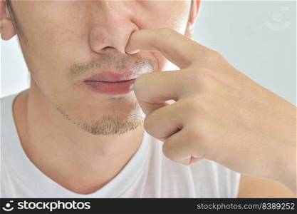 Close-up of Guy picking his nose