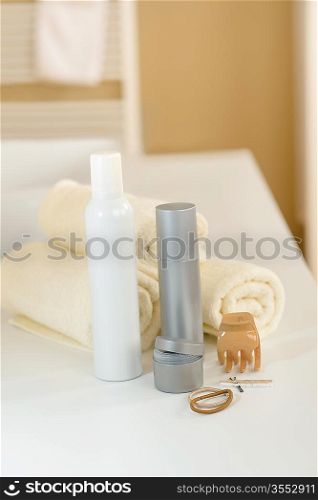Close-up of hair products and towels in bathroom