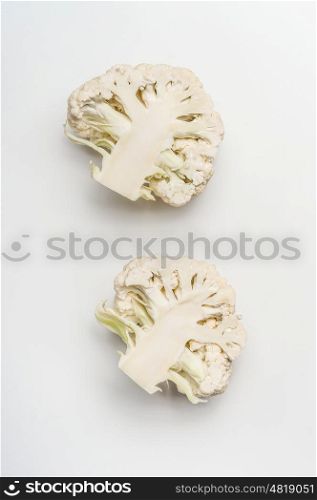 Close up of half head of cauliflower cabbage on white background, top view