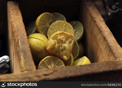 Close-up of halved lemons in wooden container