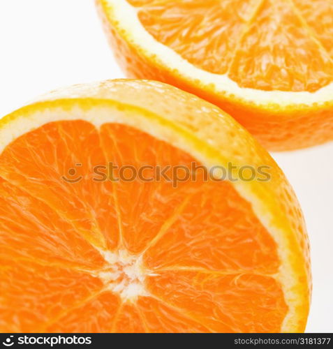 Close up of halved orange against white background.