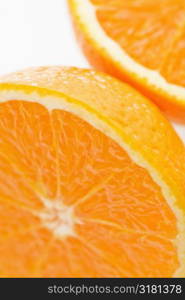 Close up of halved orange against white background.