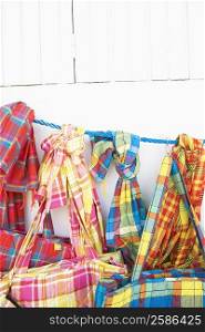 Close-up of hand bags and stoles hanging at a market stall