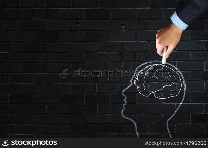 Close up of hand drawing human brain with chalk . Human brain
