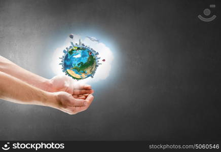 Close up of hand holding Earth planet. Elements of this image are furnished by NASA. Our planet in our hands