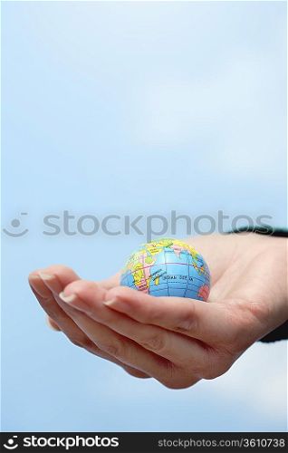 Close-up of hand holding globe