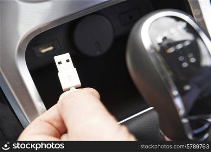 Close Up Of Hand Holding USB Connector In Car