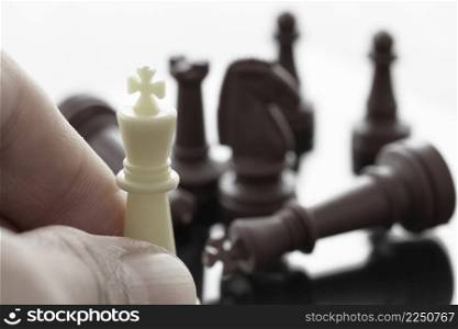 close up of hand moving chess figure on suit background as strategy or leadership concept