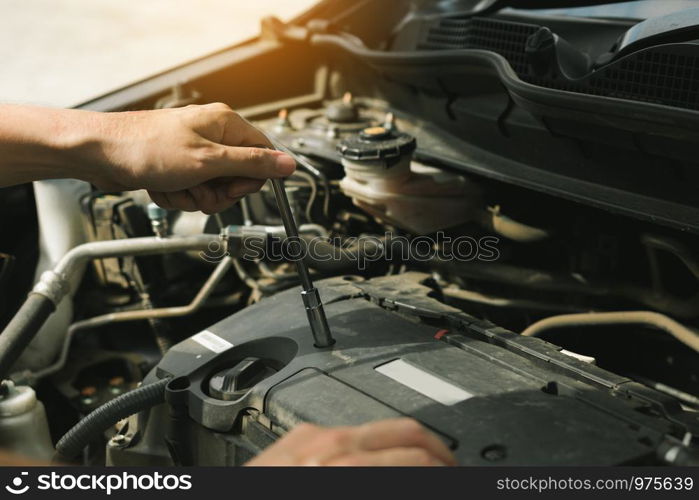 Close up of hand professional mechanic repairing a car in auto repair shop.