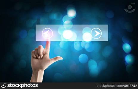 Close up of hand pushing icon of media player. Player icon
