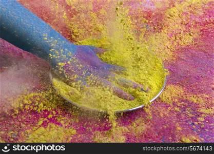 Close-up of hand splashing green powder paint during Holi festival
