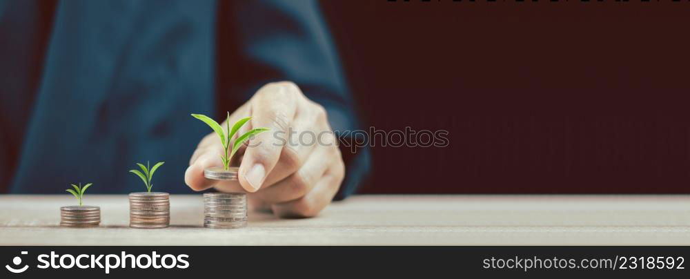 Close up of hand stacking gold coins with green bokeh background ,Business Finance and Money concept,Save money for prepare in the future.Trees growing on coin.vintage process style