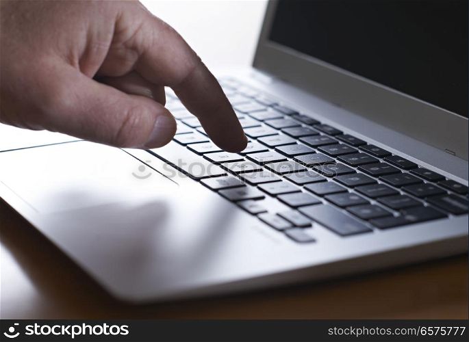Close Up Of Hand Typing On Laptop Keyboard