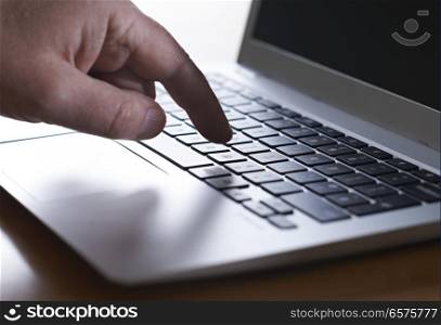 Close Up Of Hand Typing On Laptop Keyboard
