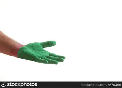 Close-up of hand with green power paint during Holi festival over white background