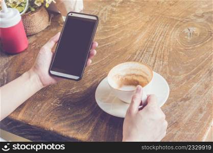 close up of hand woman using smartphone in coffee shop