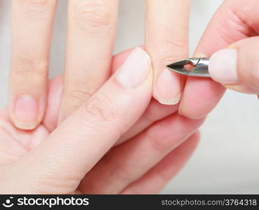 Close up of hands. Beautician trimming cuticles of female client. Manicure and skincare. Woman in spa beauty salon.