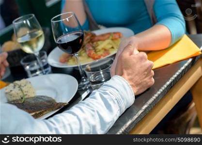close up of hands holding over dinner