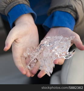 Close-up of hands holding pieces of ice, Lake Of The Woods, Ontario, Canada