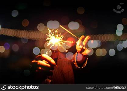 Close up of Hands Holding Sparklers At Night, Firework celebrate at night