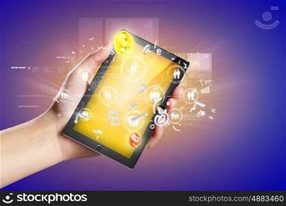 Close-up of hands holding tablet pc. Close-up image of male hands holding tablet pc