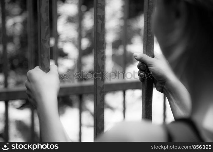 Close up of hands in a prison cell, jail