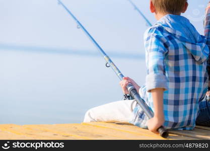 Close-up of hands of a boy with a fishing rod. Close-up of hands of a boy with a fishing rod that is fishing on the pier