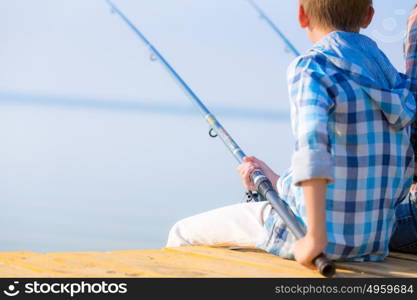 Close-up of hands of a boy with a fishing rod. Close-up of hands of a boy with a fishing rod that is fishing on the pier