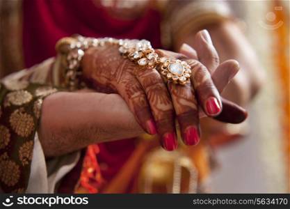 Close-up of hands of groom and bride
