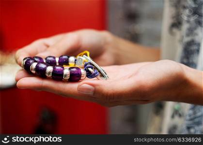 Close-up of hands of woman taking a bracelet in a jewelry store