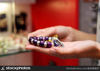Close-up of hands of woman taking a bracelet in a jewelry store